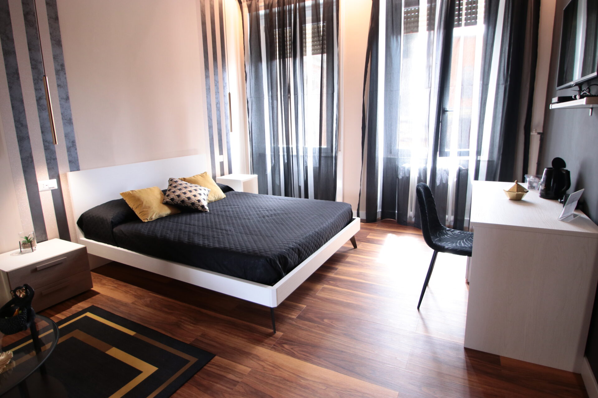 Camera da letto moderna con letto matrimoniale e scrivania.