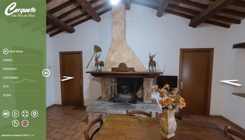 Interno rustico con camino e tavolo in legno.